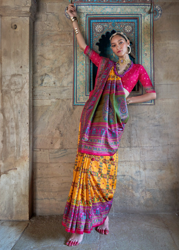 Vibrant yellow Patola silk saree with printed geometric motifs and fluid drape
