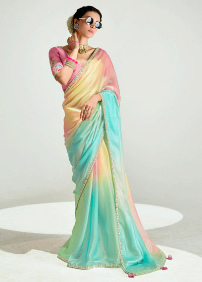 Woman wearing a pastel-colored saree with a gradient effect on a white background