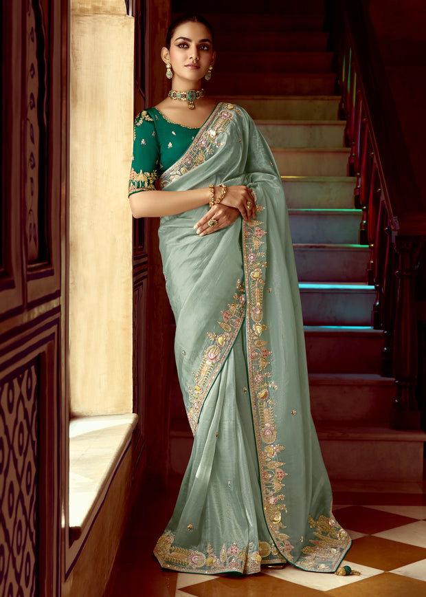 Ice green heavy embroidered silk saree with detailed motifs