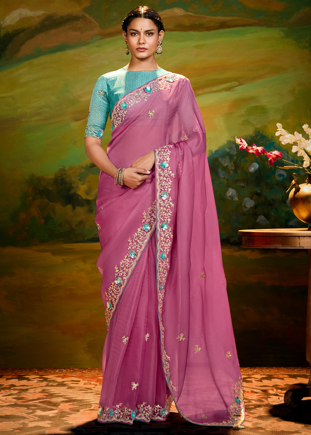 Dusky pink heavy embroidered silk saree with contrast blouse