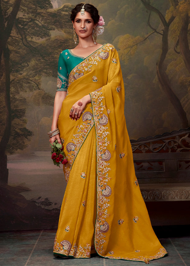 Dusky yellow heavy embroidered designer silk saree with rich embellishments