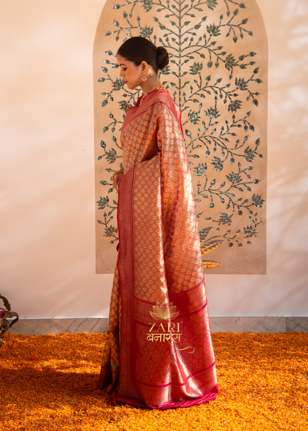 Madhavi peach Banarasi tissue saree with handwoven Meenakari butis in coloured resham