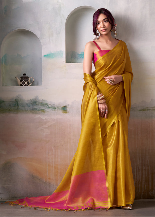 Golden yellow tissue silk saree with metallic sheen and light drape