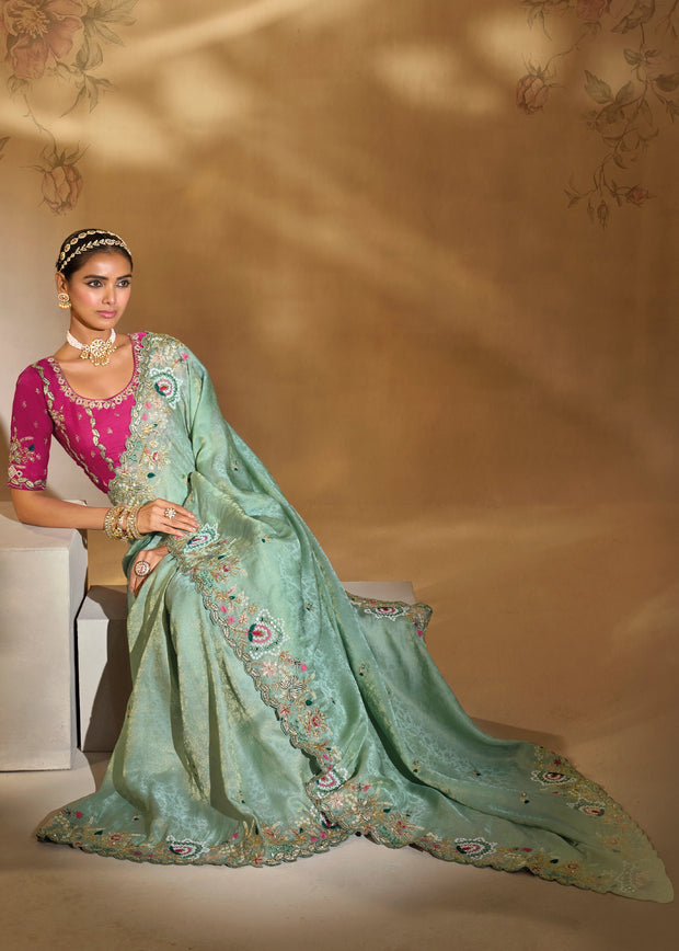 Mint green Kanjivaram silk saree with heavy hand embroidery over woven silk body