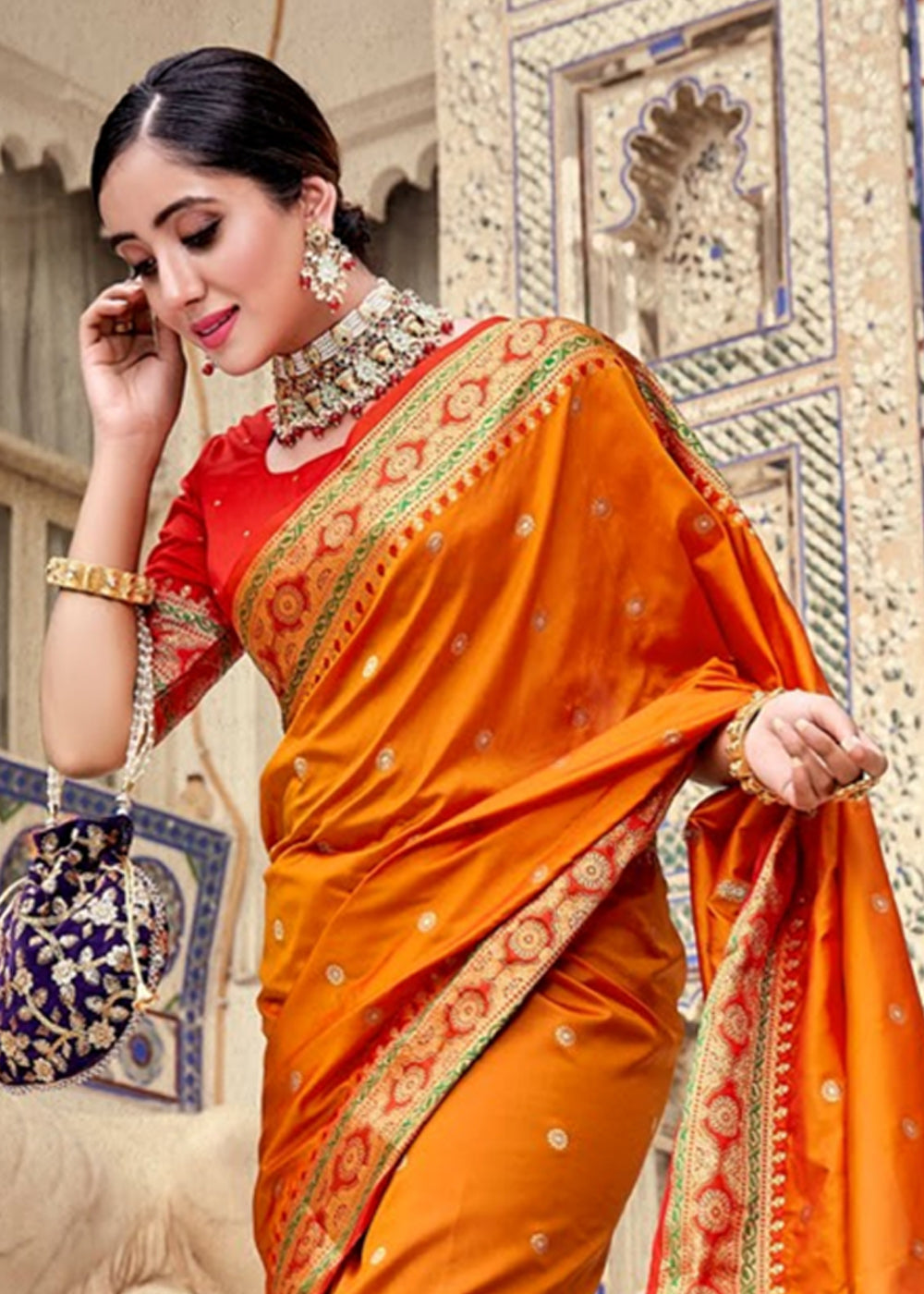 mature beautiful woman wearing Saffron colour saree aiming the bow and  arrows