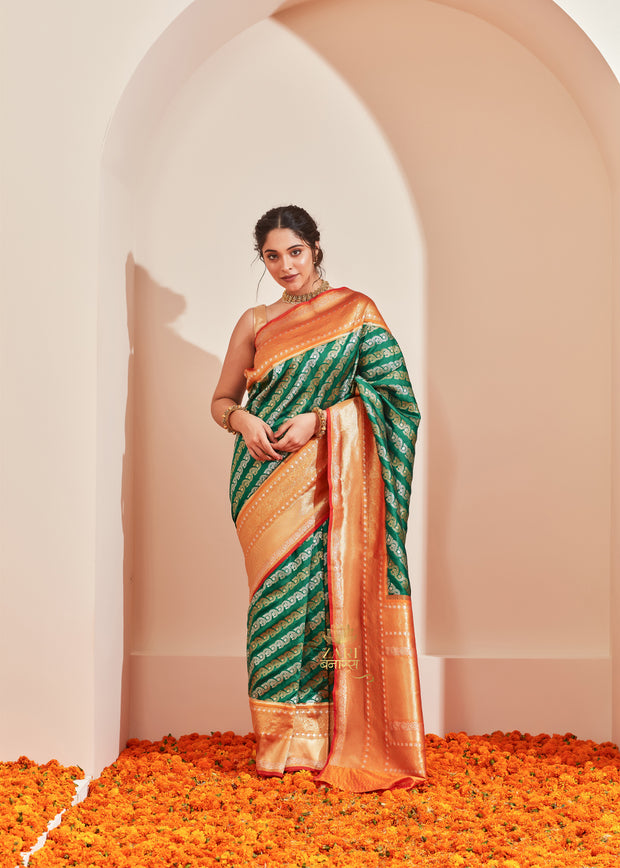 Ananda forest green Kanjivaram silk saree with alternating silver and gold zari stripes
