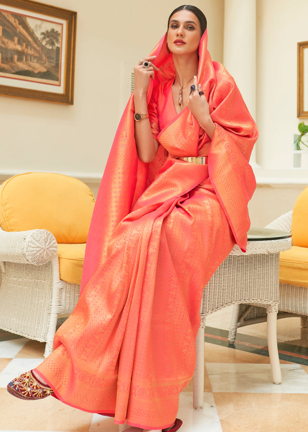 Red orange Kanjivaram silk saree with handwoven zari motifs and contrast border